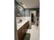 Bathroom featuring a dual sink vanity with wood cabinets and a view into the walk in closet at 351 Duncan Chapel Rd, Harleyville, SC 29448
