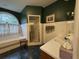 Bathroom with stylish tile floor, large soaking tub beneath a half round window, and separate stand-up shower at 351 Duncan Chapel Rd, Harleyville, SC 29448