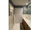 Bathroom featuring a single sink vanity, white tile, a glass enclosed shower and a doorway at 351 Duncan Chapel Rd, Harleyville, SC 29448