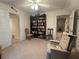 Versatile bonus room features a bookshelf, comfortable chairs, and multiple doorways at 351 Duncan Chapel Rd, Harleyville, SC 29448