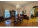 Dining room with hardwood floors, a chandelier, and a glimpse into the kitchen at 351 Duncan Chapel Rd, Harleyville, SC 29448