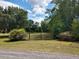 Gated entrance to a property with a long driveway leading into a wooded area at 351 Duncan Chapel Rd, Harleyville, SC 29448