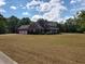 Spacious home with a three-car garage, surrounded by a large lawn and mature trees at 351 Duncan Chapel Rd, Harleyville, SC 29448