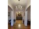 View of the foyer with hardwood floors, decorative columns, and a crystal chandelier at 351 Duncan Chapel Rd, Harleyville, SC 29448