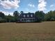 Attractive home with a covered front porch, well-maintained landscaping, and a sprawling lawn at 351 Duncan Chapel Rd, Harleyville, SC 29448