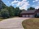Three-car garage with a large concrete driveway, offering ample parking space at 351 Duncan Chapel Rd, Harleyville, SC 29448