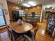 Charming kitchen with island, breakfast table, ample wood cabinets, and hardwood floors at 351 Duncan Chapel Rd, Harleyville, SC 29448