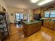 Eat-in kitchen with island, stainless-steel appliances, ample wood cabinets, and hardwood floors at 351 Duncan Chapel Rd, Harleyville, SC 29448