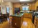 Open eat-in kitchen with island, stainless-steel appliances, ample cabinets, and hardwood floors at 351 Duncan Chapel Rd, Harleyville, SC 29448
