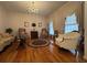 Cozy living room with large windows, hardwood floors, and comfortable seating at 351 Duncan Chapel Rd, Harleyville, SC 29448