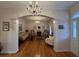 Bright and airy living room featuring hardwood floors, arched doorways, and a crystal chandelier at 351 Duncan Chapel Rd, Harleyville, SC 29448