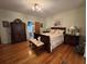 Cozy main bedroom features hardwood floors, a beautiful quilt, and and nightstands and dressers at 351 Duncan Chapel Rd, Harleyville, SC 29448