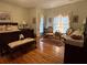 Comfortable main bedroom with hardwood floors, chair sitting area, and large windows for lots of natural light at 351 Duncan Chapel Rd, Harleyville, SC 29448