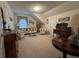 Cozy sitting area features wicker furniture and sloped ceilings at 351 Duncan Chapel Rd, Harleyville, SC 29448