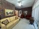 Sunroom showcasing comfortable furniture, exposed brick, and plenty of natural light from windows at 351 Duncan Chapel Rd, Harleyville, SC 29448