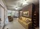 Sunroom featuring exposed brick accent wall, comfortable seating, and abundant natural light through many windows at 351 Duncan Chapel Rd, Harleyville, SC 29448