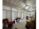A spacious sunroom featuring a neutral color palette and abundant natural light from surrounding windows at 351 Duncan Chapel Rd, Harleyville, SC 29448