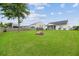 Expansive, well-maintained backyard featuring a cozy firepit and trampoline for Gathering fun and relaxation at 405 Watershed Dr Dr, Goose Creek, SC 29445