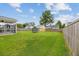 Green backyard featuring screened porch, new fence, and trampoline, providing a private outdoor oasis at 405 Watershed Dr Dr, Goose Creek, SC 29445