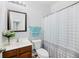 Standard bathroom with a dark wood vanity, white toilet, a patterned shower curtain and a framed mirror at 405 Watershed Dr Dr, Goose Creek, SC 29445