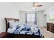 Cozy bedroom featuring a queen-sized bed, a ceiling fan, a window, and a dresser at 405 Watershed Dr Dr, Goose Creek, SC 29445