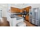 Kitchen featuring wood cabinets, stainless steel appliances, a gray countertop, and a backsplash at 405 Watershed Dr Dr, Goose Creek, SC 29445