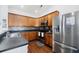 Kitchen featuring wood cabinets, stainless steel appliances, a gray countertop, and dark laminate flooring at 405 Watershed Dr Dr, Goose Creek, SC 29445