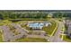 Stunning aerial view of community pool, splash pad and other amenities with lush landscaping and a surrounding neighborhood at 444 Cedarview Rd, Summerville, SC 29486