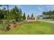 The entrance to Pine Hills featuring a stone sign and landscaping under a blue sky at 444 Cedarview Rd, Summerville, SC 29486