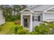 Charming home entrance with gray siding, black door with welcome sign, and lush green landscaping at 444 Cedarview Rd, Summerville, SC 29486
