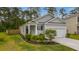 Inviting home with a classic gray facade, complemented by a charming porch and meticulous landscaping at 444 Cedarview Rd, Summerville, SC 29486