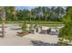 Community grilling area with stone countertops, a splashpad and bar seating near a tranquil lake at 444 Cedarview Rd, Summerville, SC 29486