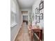 Bright hallway featuring wood-look flooring, console table with decor and natural light streaming through a window at 444 Cedarview Rd, Summerville, SC 29486