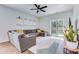 Bright living room features a comfortable sectional sofa, modern ceiling fan, and access to the outdoors at 444 Cedarview Rd, Summerville, SC 29486