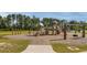 A charming wooden playground with climbing structures and swings, set in a community park at 444 Cedarview Rd, Summerville, SC 29486
