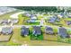 Aerial view of suburban homes with lush lawns and a scenic pond in the neighborhood at 447 Navona Dr, Summerville, SC 29486