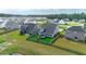 Aerial view of the fenced-in backyard with a playset surrounded by lush green grass at 447 Navona Dr, Summerville, SC 29486