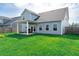 Spacious backyard featuring a covered patio, a lush green lawn, and a fenced perimeter at 447 Navona Dr, Summerville, SC 29486