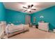 Bright bedroom with teal walls, ceiling fan, and a comfy bed at 447 Navona Dr, Summerville, SC 29486