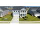 Charming two-story home featuring a light blue facade, a second story balcony, and a well manicured lawn at 447 Navona Dr, Summerville, SC 29486