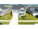 Charming two-story home featuring a light blue facade, a second story balcony, and a well manicured lawn at 447 Navona Dr, Summerville, SC 29486