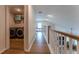 Second-floor hallway with wood floors leading to laundry and main bedroom at 447 Navona Dr, Summerville, SC 29486