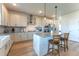 Well-lit kitchen with an island, stainless steel appliances, and stylish pendant lighting at 447 Navona Dr, Summerville, SC 29486