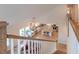 Aerial view of a well-lit kitchen, adjacent living room, and staircase leading to the second floor at 447 Navona Dr, Summerville, SC 29486