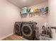 Laundry room featuring front load washer and dryer, storage shelving, and hardwood floors at 447 Navona Dr, Summerville, SC 29486