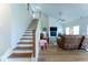 Open living space with hardwood floors, fireplace, and staircase leading to the second floor at 447 Navona Dr, Summerville, SC 29486
