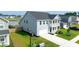 Charming two-story home with light blue facade, attached two-car garage, and manicured green lawn at 447 Navona Dr, Summerville, SC 29486