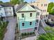An aerial view of a two-story home with an open parking area, a two-car garage, and balconies at 48 Aiken St, Charleston, SC 29403