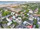 An aerial view featuring Charleston homes intermingled with lush greenery near industrial complexes and roadways at 48 Aiken St, Charleston, SC 29403