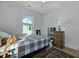 Comfortable bedroom with hardwood floors, neutral paint, ceiling fan, and window views at 48 Aiken St, Charleston, SC 29403